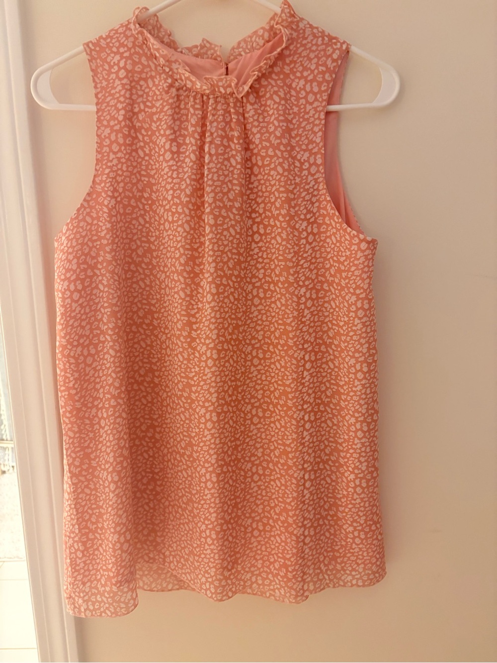 Womana Sleeveless Pink Printed Ruffle-Neck blouse